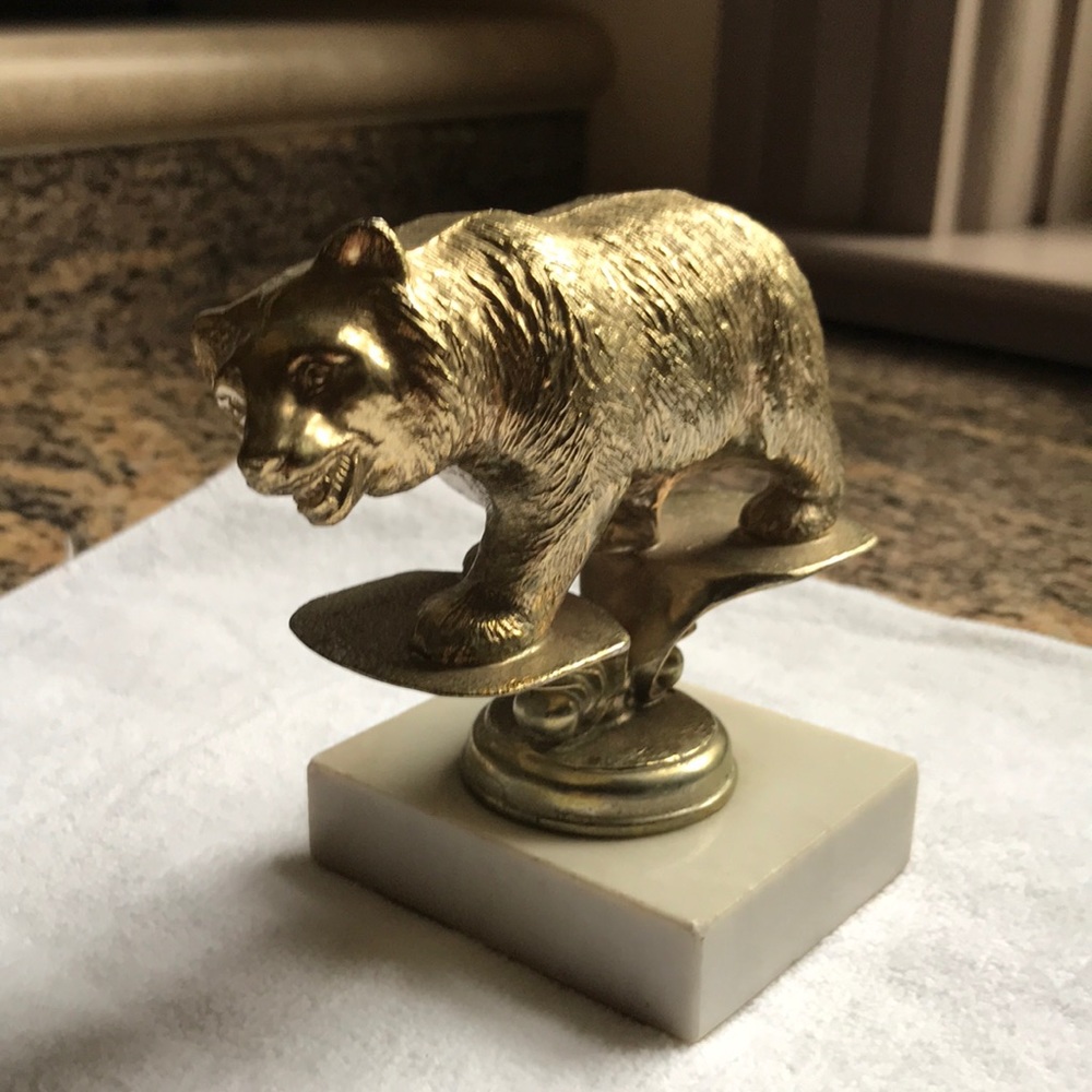 Vintage brass bear statue on Italian marble